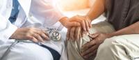 Photo of a physician comforting a patient